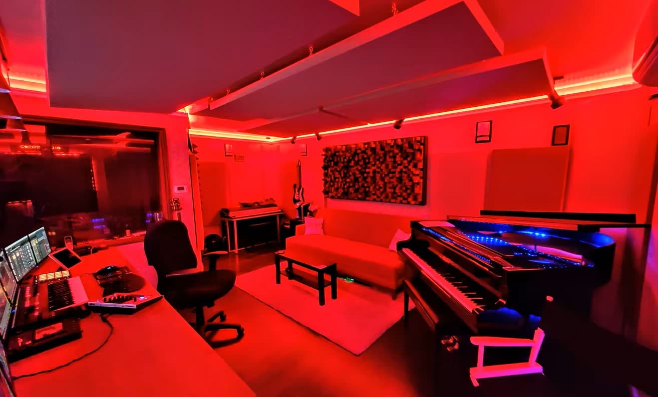 Recording studio main room — grand piano, acoustic panels, LED ambient lighting, Los Angeles