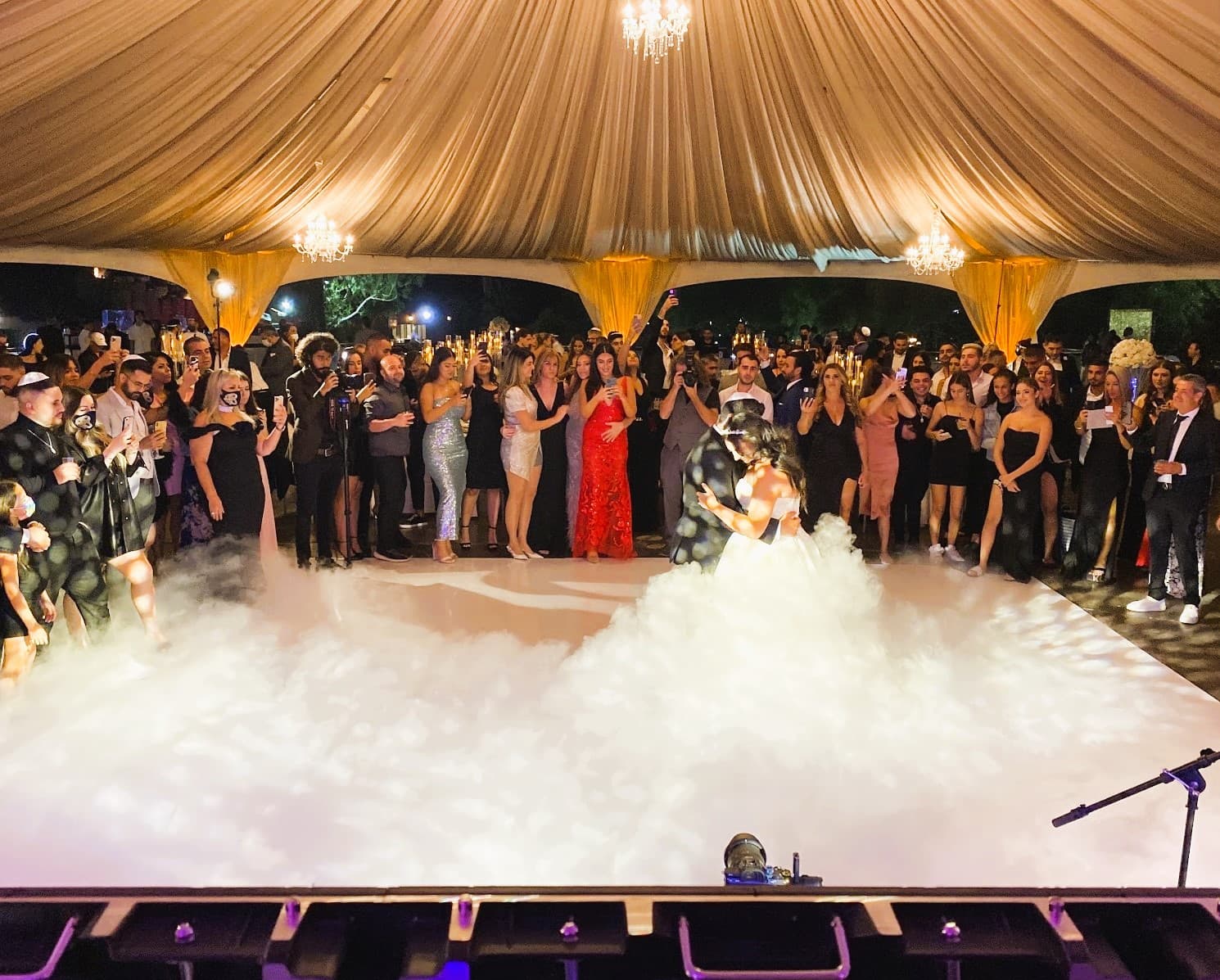Bride and groom's first dance on clouds (dancing on clouds low-fog effect) at an On Air Productions LA wedding in Los Angeles