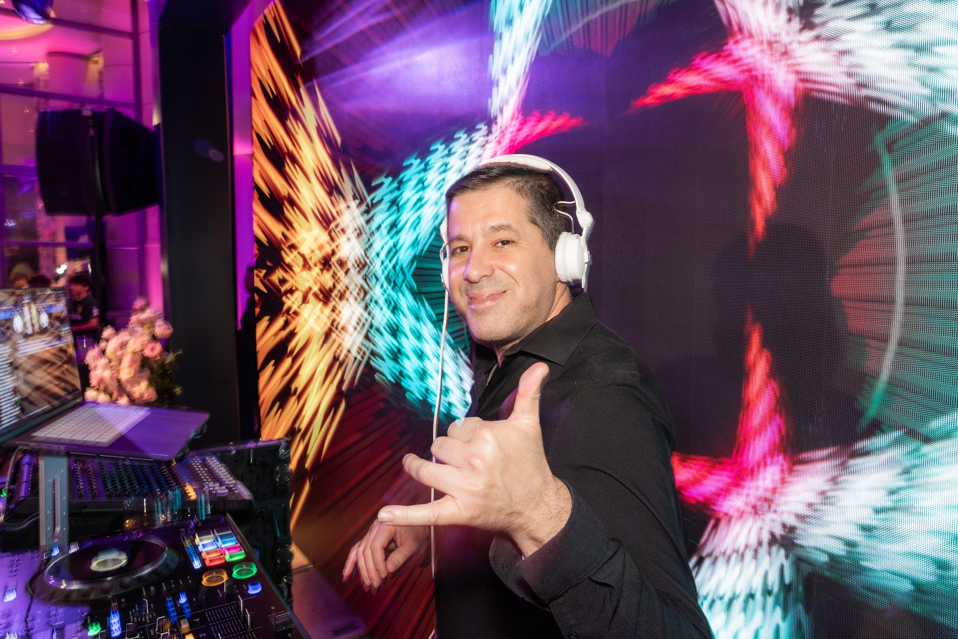 DJ Gilad Emesh with headphones performing at a Los Angeles event