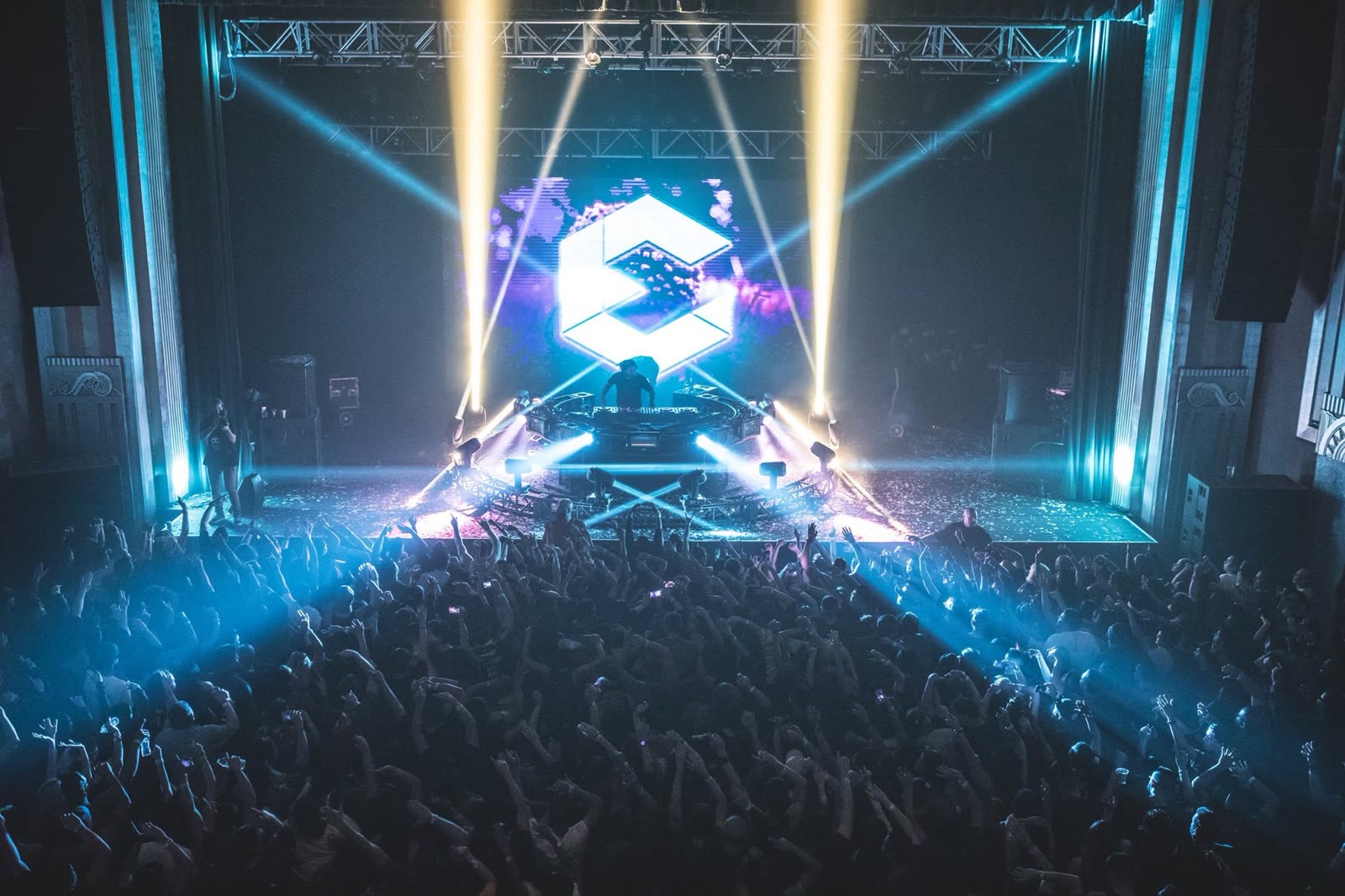 DJ Ori performing on a festival main stage with lasers